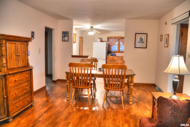 dining room with wood-type flooring and ceiling fan