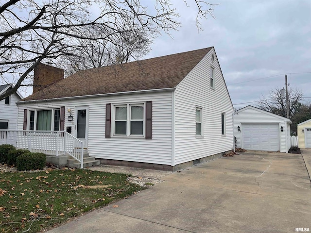 view of front of home with an outbuilding, a front lawn, and a garage