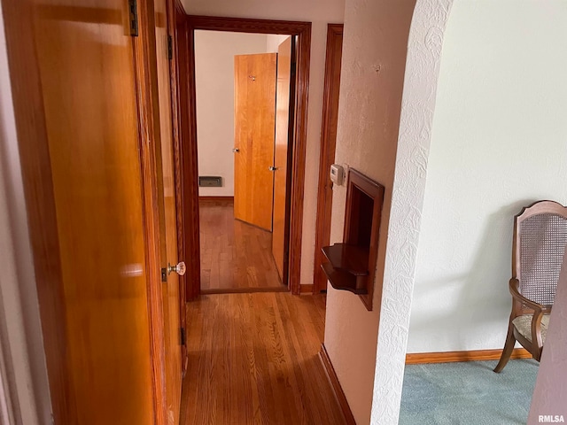 hall featuring wood-type flooring