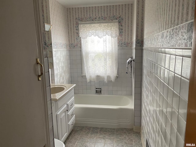 bathroom featuring tile patterned floors, vanity, and tile walls