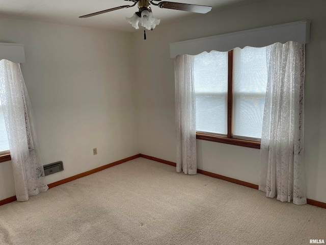 empty room featuring ceiling fan and carpet floors