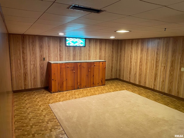 bar featuring wood walls and light parquet flooring