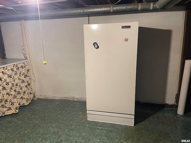 basement with white refrigerator