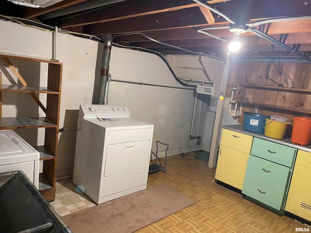 basement with washer / dryer and light parquet flooring