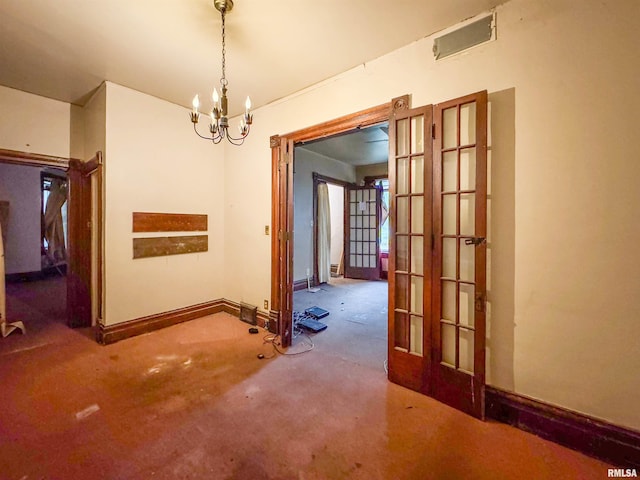 unfurnished dining area featuring carpet, french doors, and a chandelier