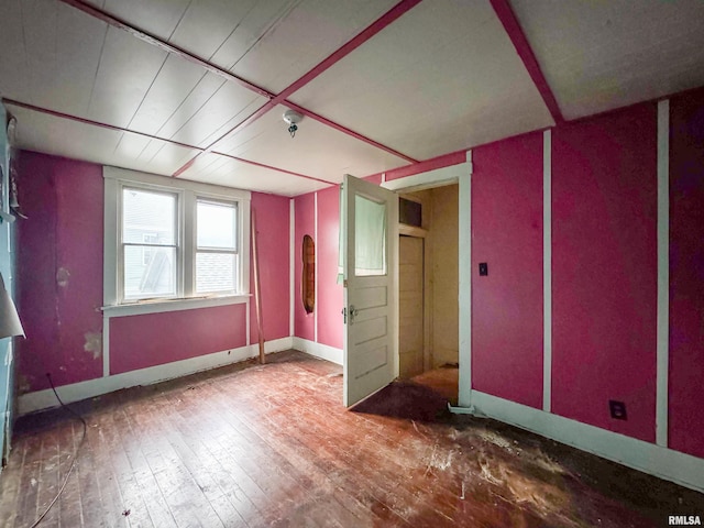 spare room featuring wood-type flooring