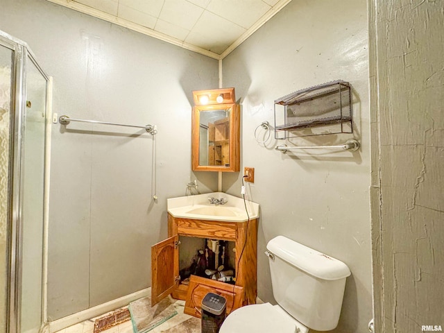 bathroom with vanity, toilet, an enclosed shower, and crown molding