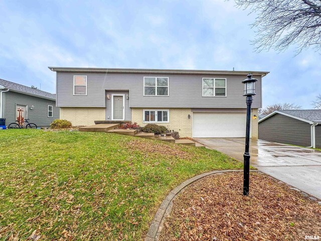 raised ranch with a garage and a front yard