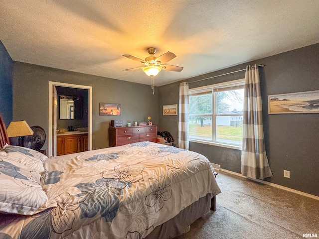 bedroom with sink, ceiling fan, a textured ceiling, connected bathroom, and carpet floors