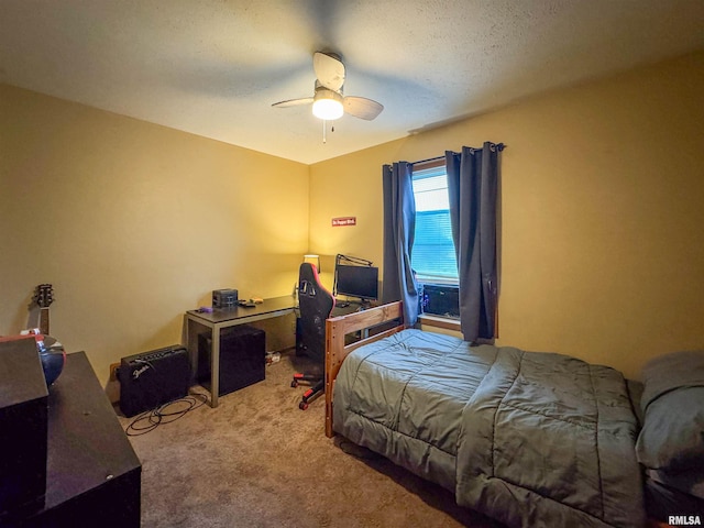 bedroom featuring ceiling fan, carpet floors, and a textured ceiling