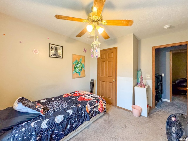 carpeted bedroom with a textured ceiling and ceiling fan