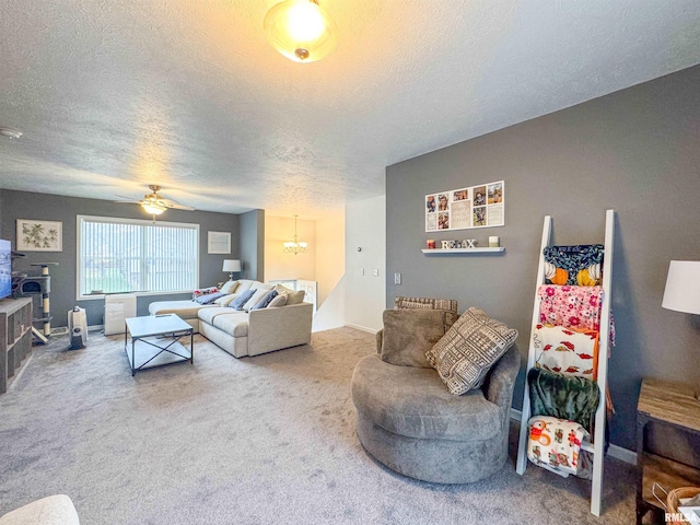 living room with ceiling fan with notable chandelier, carpet floors, and a textured ceiling