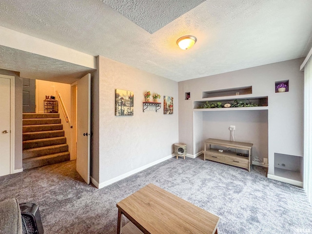 living room with carpet and a textured ceiling