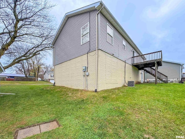 view of property exterior with a lawn, a wooden deck, and central AC