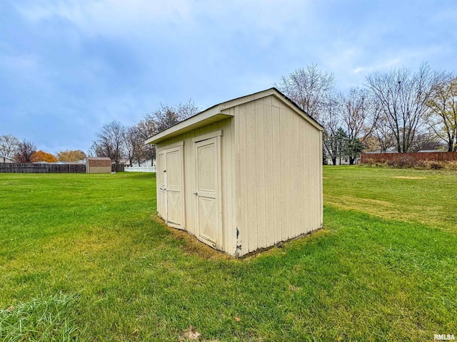 view of outdoor structure featuring a lawn