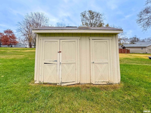 view of outdoor structure with a lawn