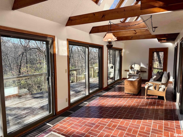 sunroom with plenty of natural light and beam ceiling