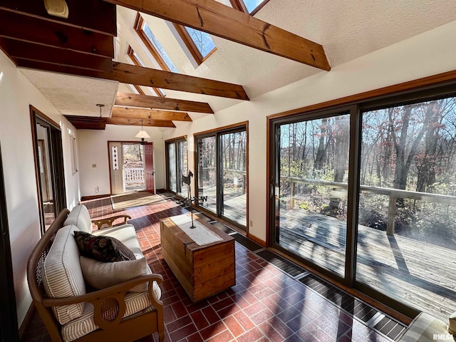 sunroom with vaulted ceiling with skylight