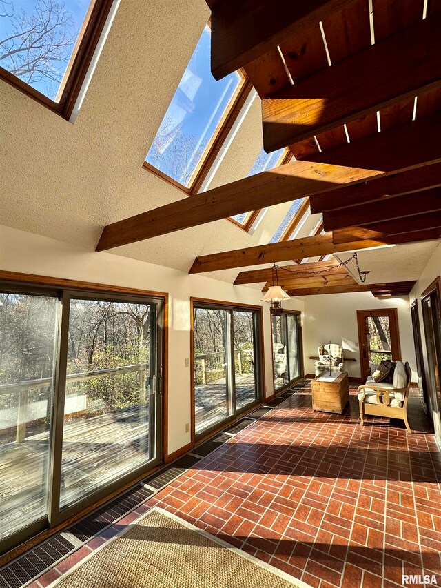 interior space with vaulted ceiling with skylight