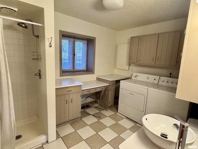 laundry room with laundry area, a sink, washer and clothes dryer, and a textured ceiling