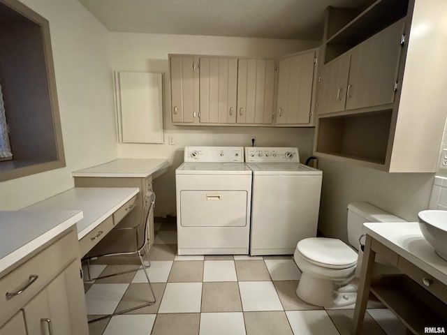 clothes washing area featuring laundry area, washer and dryer, and light tile patterned flooring