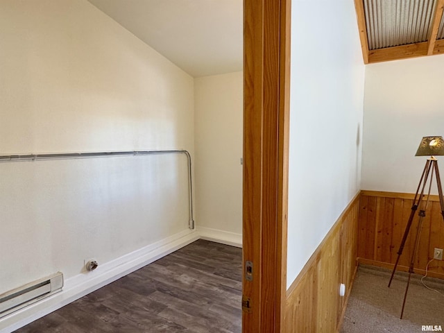 washroom featuring a wainscoted wall, dark wood-style flooring, baseboard heating, and wooden walls