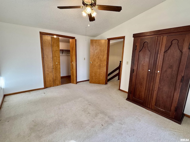 10110 E 850th St, Colchester, IL 62326 - unfurnished bedroom featuring light carpet, vaulted ceiling, a textured ceiling, baseboards, and a ceiling fan