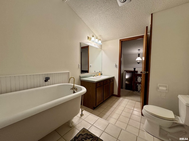 10110 E 850th St, Colchester, IL 62326 - bathroom with a freestanding tub, a textured ceiling, vanity, toilet, and tile patterned floors
