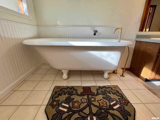 full bathroom with tile patterned flooring, wainscoting, and a freestanding bath