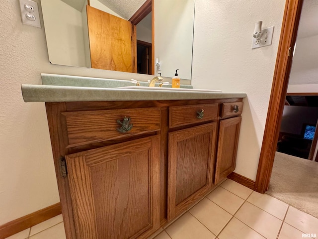 bathroom featuring baseboards, vanity, and tile patterned floors