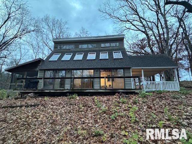 rear view of property with a shingled roof