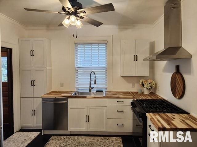 kitchen featuring stainless steel dishwasher, wall chimney exhaust hood, high end black range oven, and butcher block counters