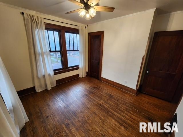 unfurnished bedroom with ceiling fan, dark hardwood / wood-style flooring, and crown molding