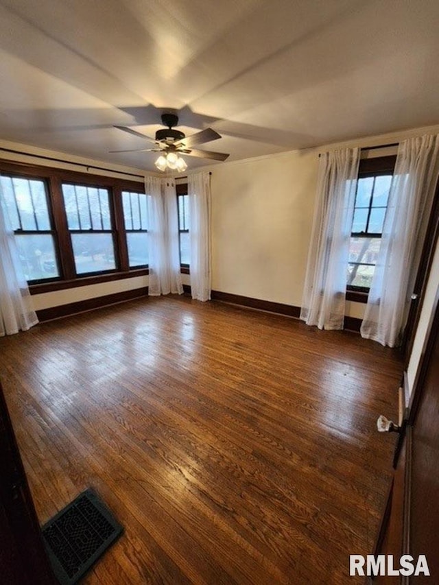 unfurnished room featuring ceiling fan and dark hardwood / wood-style flooring