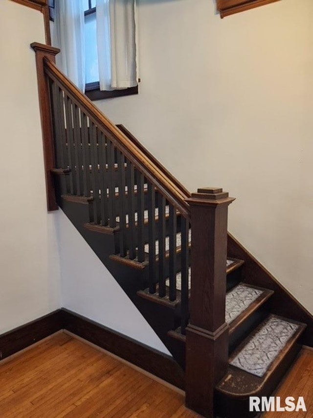 staircase with hardwood / wood-style flooring