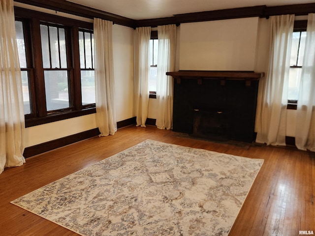 unfurnished living room featuring hardwood / wood-style flooring and a wealth of natural light