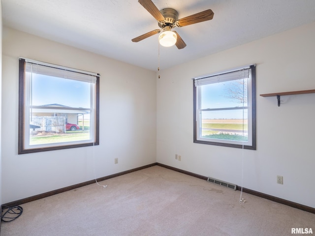 carpeted empty room with ceiling fan