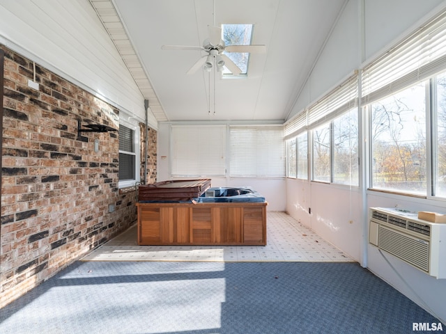 unfurnished sunroom featuring a jacuzzi, plenty of natural light, and vaulted ceiling with skylight