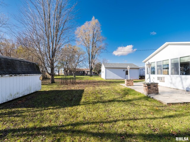 view of yard featuring an outbuilding and a patio