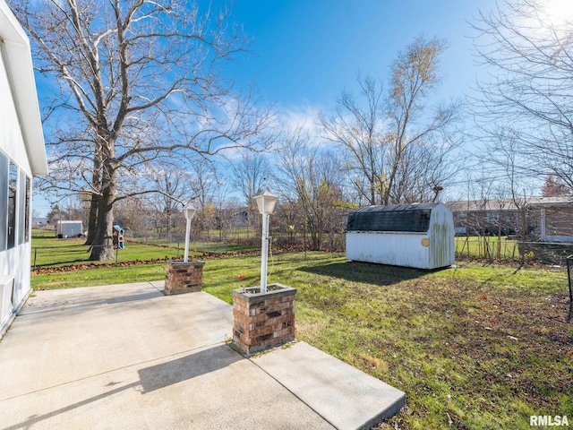 view of yard featuring a patio area and a storage unit