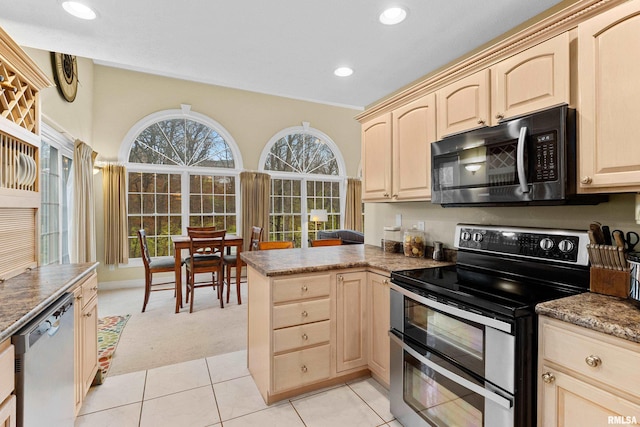 kitchen with kitchen peninsula, light brown cabinets, stainless steel appliances, and light tile patterned flooring