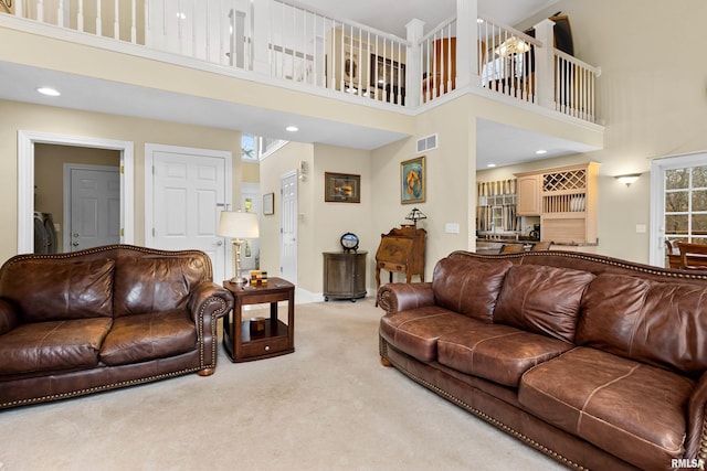 living room featuring carpet and a towering ceiling