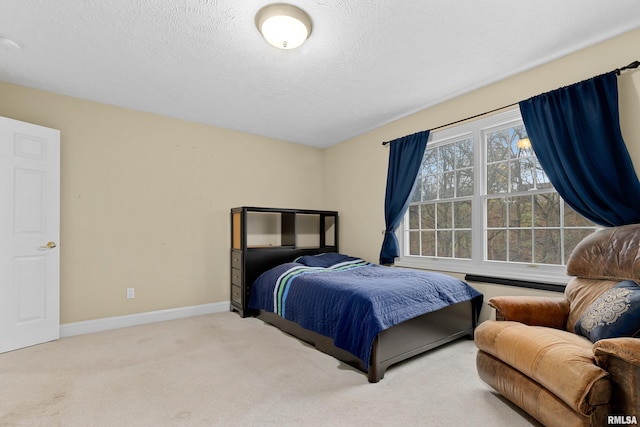 bedroom featuring carpet flooring and a textured ceiling