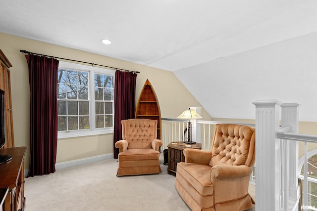 sitting room featuring light colored carpet and vaulted ceiling