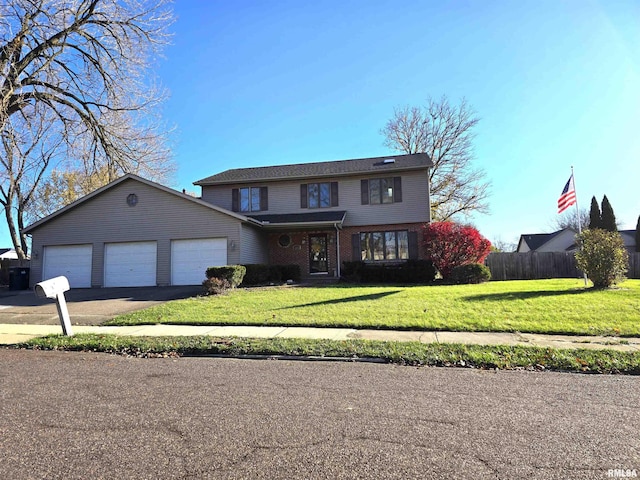 view of property with a garage and a front lawn