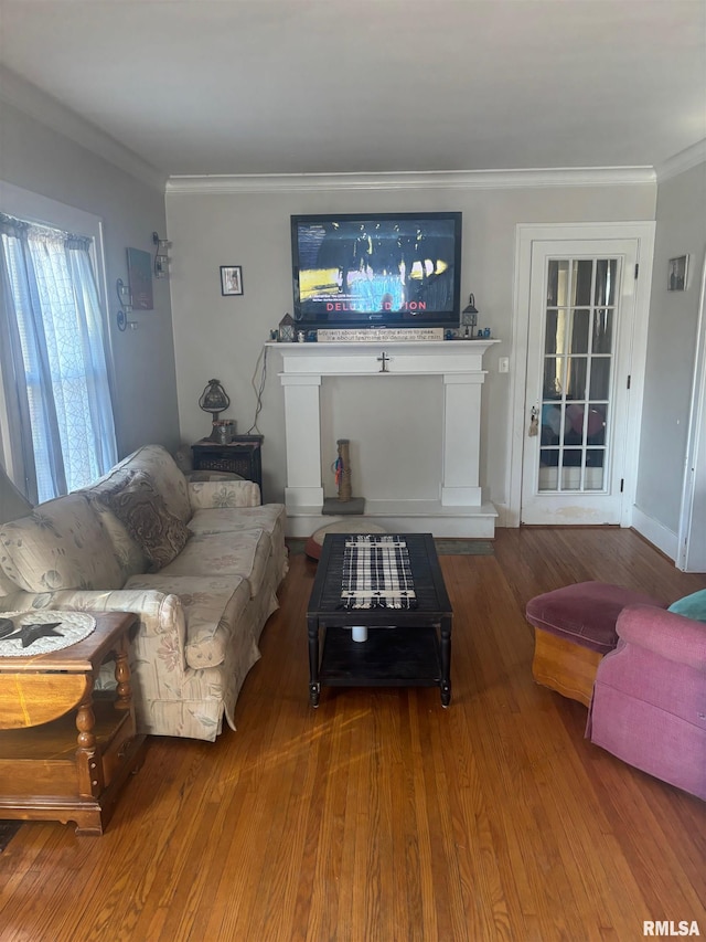 living room with wood-type flooring and ornamental molding