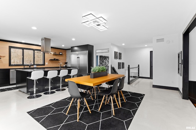 dining room with baseboards, recessed lighting, visible vents, and finished concrete floors