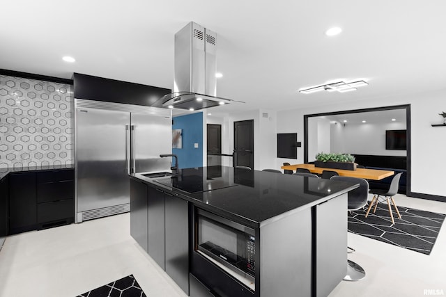 kitchen featuring island range hood, dark countertops, modern cabinets, dark cabinetry, and black appliances