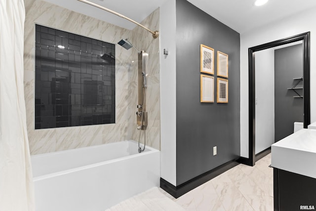 bathroom with marble finish floor, shower / bath combo, vanity, and baseboards