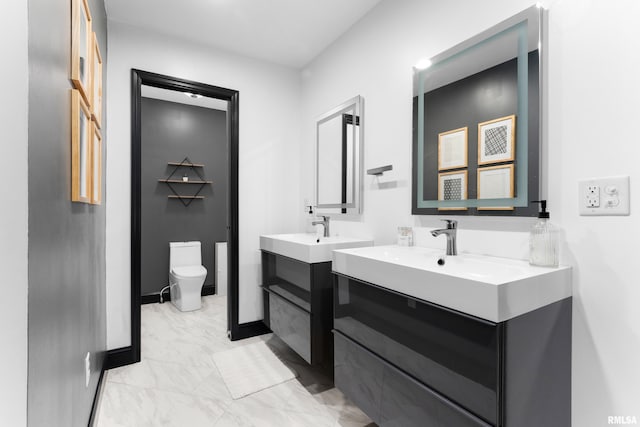 bathroom with baseboards, toilet, a sink, marble finish floor, and two vanities